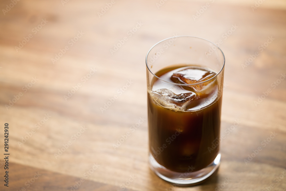 Glass of iced coffee on wooden table Glass of iced coffee on wooden table