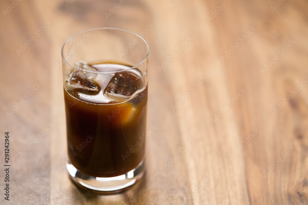 Glass of iced coffee on wooden table Glass of iced coffee on wooden table