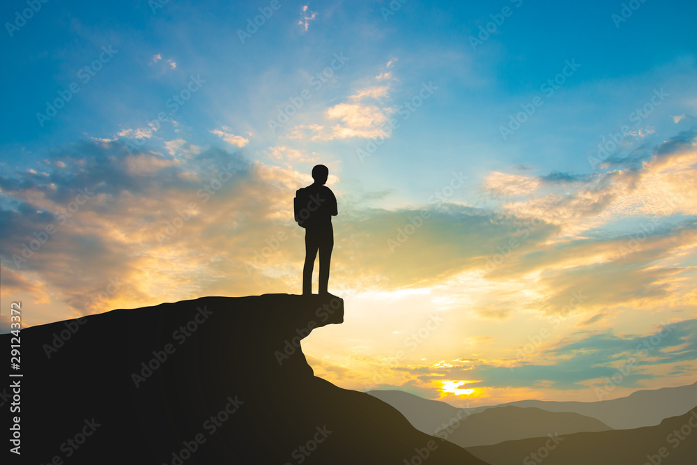 silhouette of backpacker on mountain top over sky and sun light background,business, success, leadership, achievement and people concept