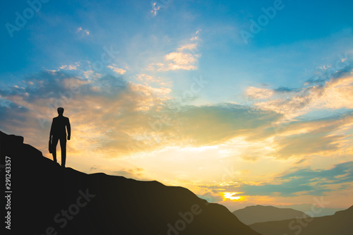 silhouette of man on mountain top over sky and sun light background,business, success, leadership, achievement and people concept © BNMK0819
