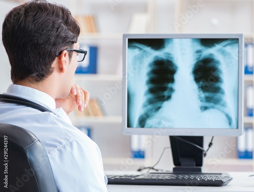 Doctor radiologist looking at x-ray images photo