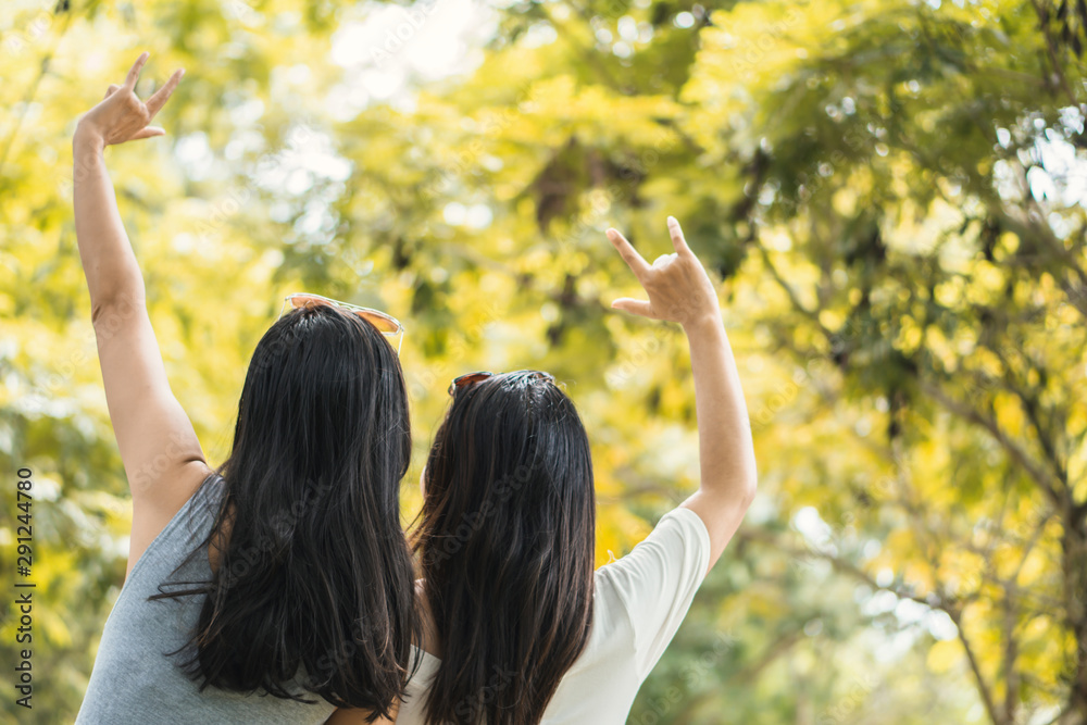 two Asian female hipster happy traveling in autumn forest enjoying nature two Asian female hipster happy traveling in autumn forest enjoying nature