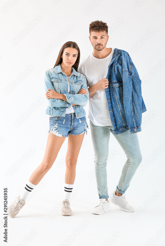 Fashionable young couple on white background Fashionable young couple on white background