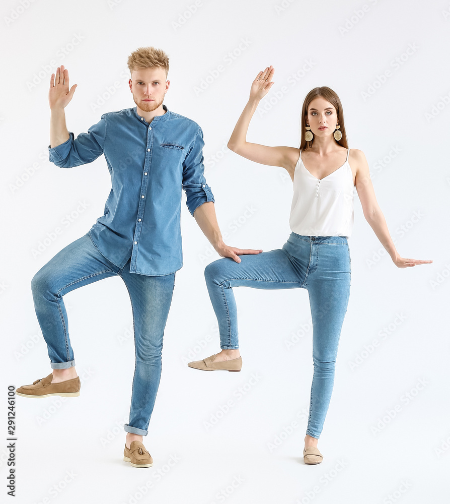 Fototapeta premium Fashionable young couple in stylish casual clothes on white background