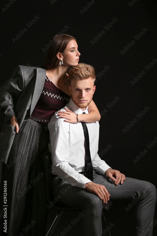 Portrait of fashionable young couple on dark background Portrait of fashionable young couple on dark background