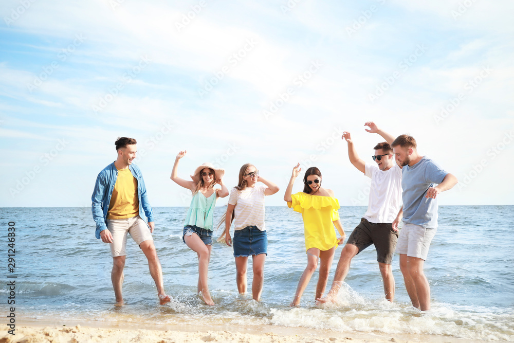 Happy friends having fun on sea beach at resort Happy friends having fun on sea beach at resort