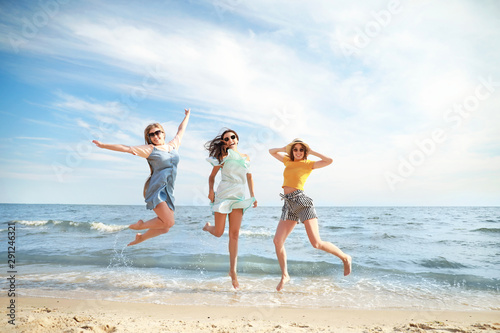 Happy jumping young women o...