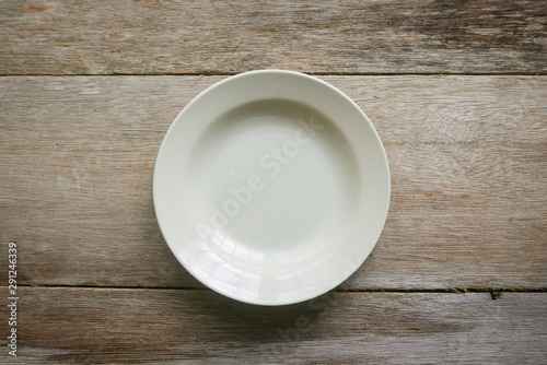 Top view of an empty plate on wooden background.