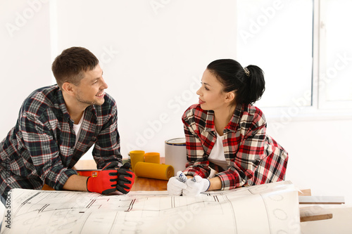 Happy couple doing repair i...