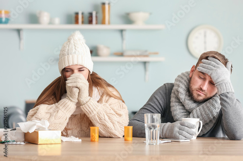 Sick couple sitting at kitc...