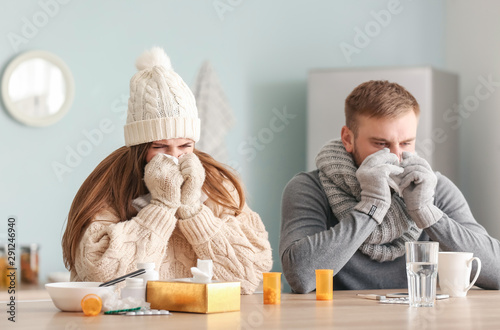 Sick couple sitting at kitc...