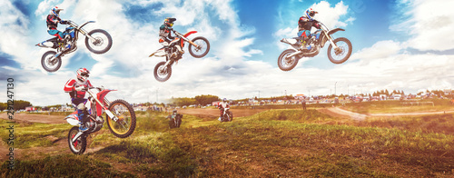 Banner rider on mountain dirtbike enduro participates in motocross, jumps on springboard against background dirt. Concept extreme action sport racing