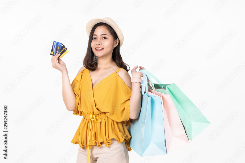 Asian woman in summer casual clothes.Asian Smiling woman .Beautiful Attractive asian woman smile and holding pastel bags on white background,isolated.Shopping happy concept. Asian woman in summer casual clothes.Asian Smiling woman .Beautiful Attractive asian woman smile and holding pastel bags on white background,isolated.Shopping happy concept.