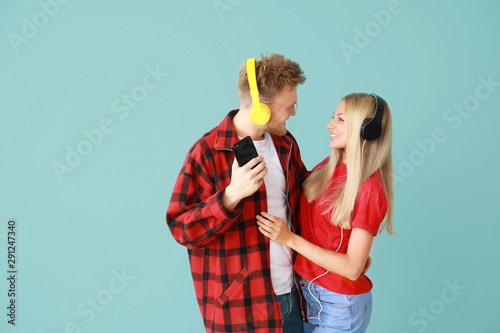 Young couple listening to m...