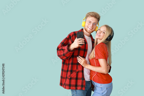 Young couple listening to m...