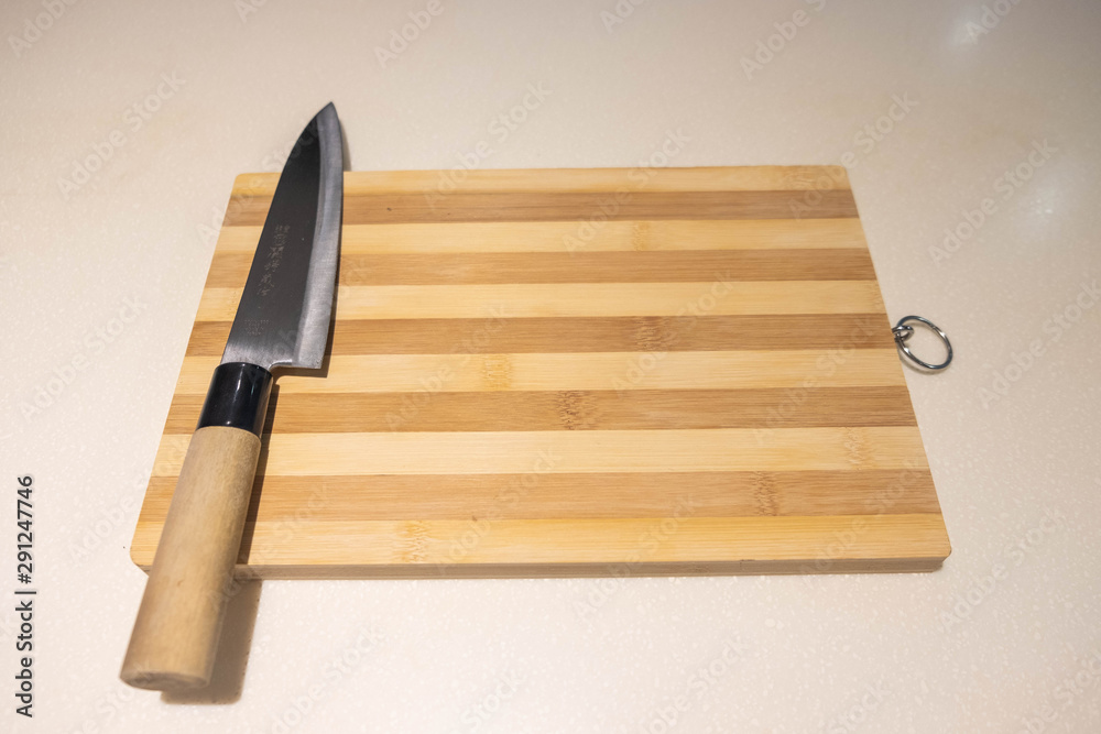 cutting knife on top of wooden cutting board