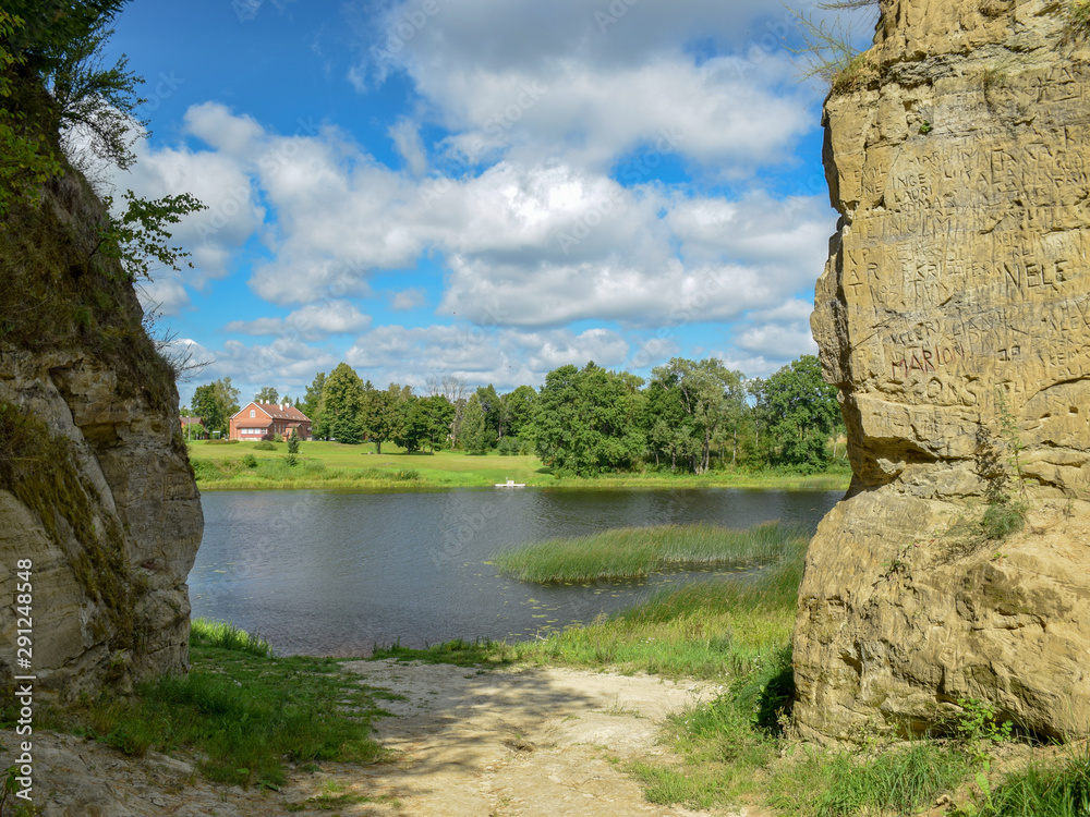 picture of steep stone banks with stone rocks and tree roots on the Pernava river, Estonia picture of steep stone banks with stone rocks and tree roots on the Pernava river, Estonia