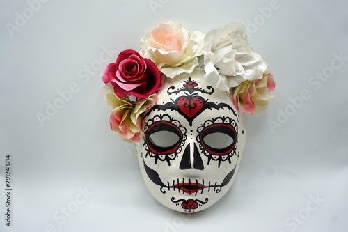 Sugar skull mask with flowers used for celebrating Day of the Dead in hispanic culture.