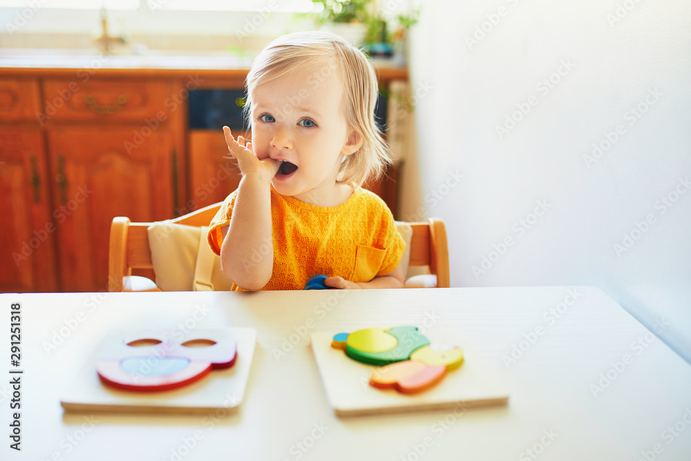 Adorable toddler girl doing wooden puzzle Adorable toddler girl doing wooden puzzle