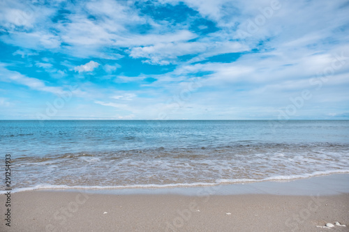 Landscape image of tropical white beach with blue sea and sky background