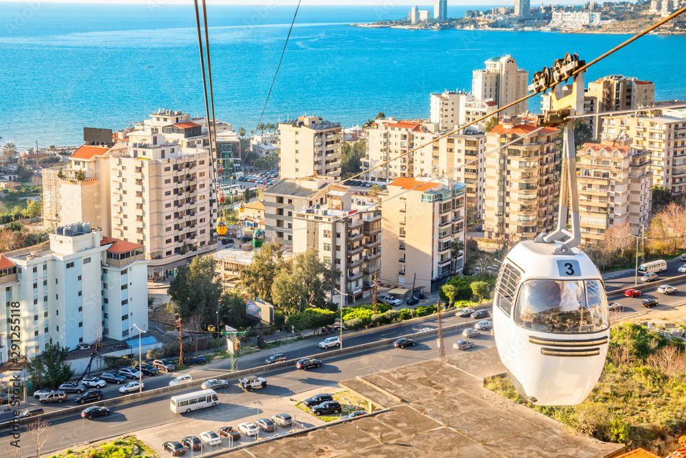 Obraz premium Cable car over the residence district with blue sea in the background, Jounieh, Keserwan District,, Lebanon