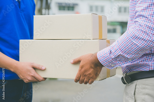 Hand accepting a delivery of boxes from deliveryman.