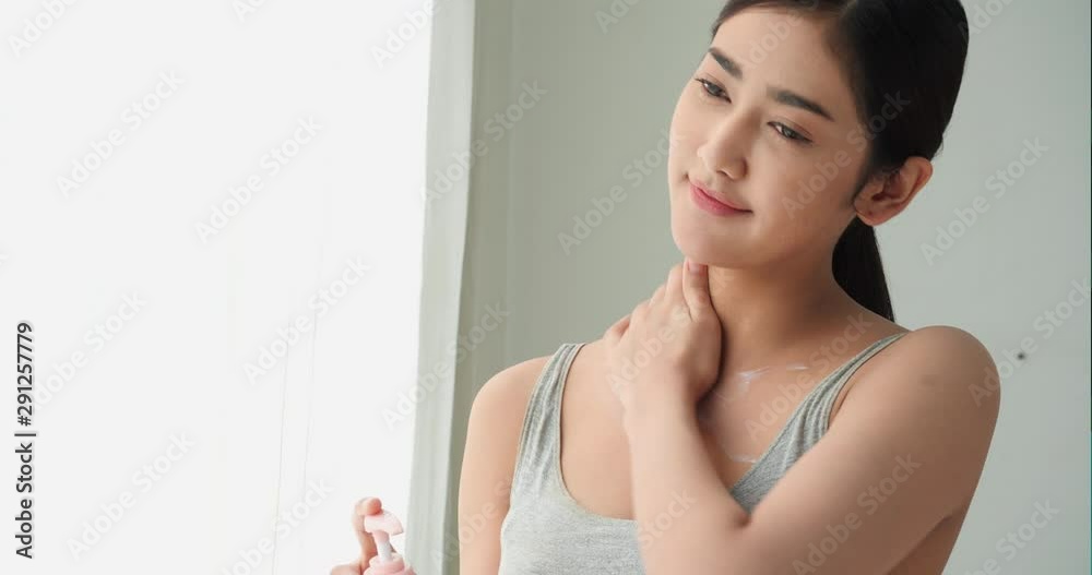Asian beautiful woman apply perfume lotion cream on the body. Young woman take care self because love skin of body. Concept of beauty, health and cosmetics. Asian beautiful woman apply perfume lotion cream on the body. Young woman take care self because love skin of body. Concept of beauty, health and cosmetics.