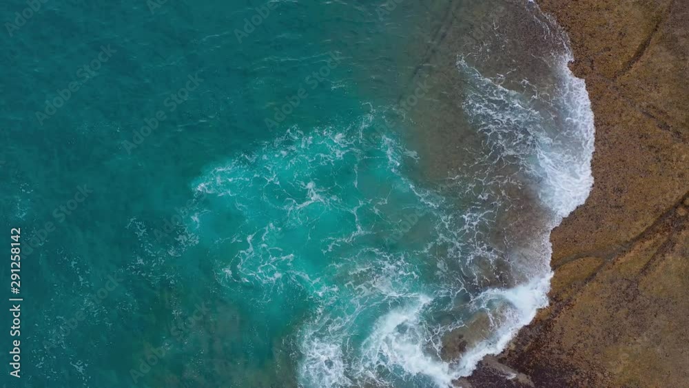 Top view of the desert stony coast on the Atlantic Ocean. Coast of the island of Tenerife. Aerial drone footage of sea waves reaching shore Top view of the desert stony coast on the Atlantic Ocean. Coast of the island of Tenerife. Aerial drone footage of sea waves reaching shore