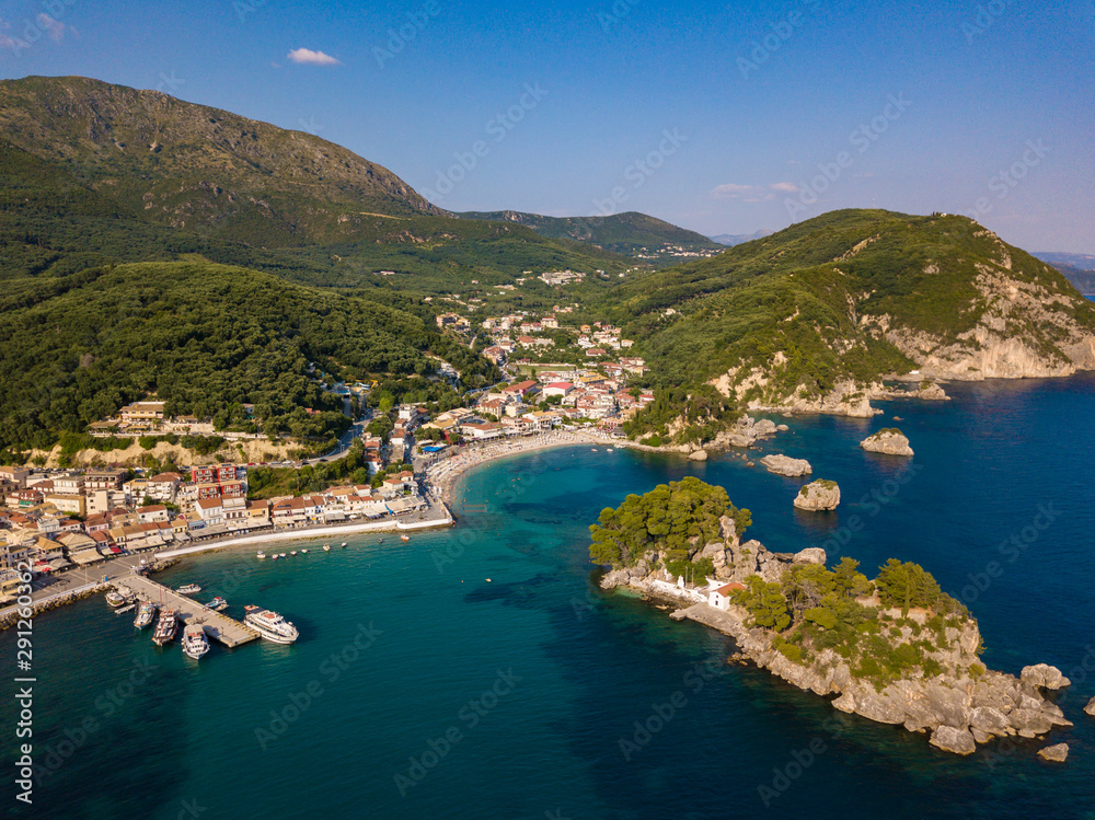 Parga Greece and Panagia Island aerial view. Crystal water natural landscape and beautiful architectural buildings near the port of Parga Epirus, Greece, Europe.
