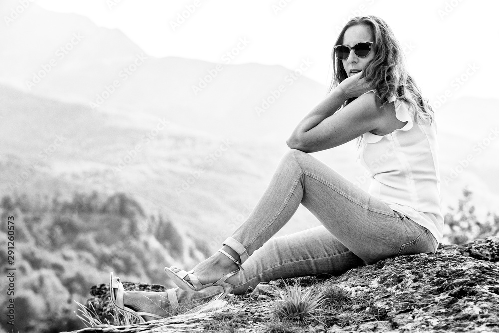Bella donna seduta in montagna con tacchi alti Stock Photo Adobe