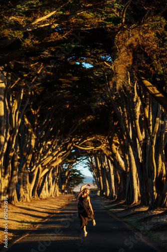 Happy girl in a tunnel with trees