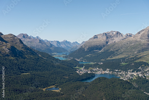 The lake region with the lakes of St. Moritz, Champfèrsee, Silvaplaner See and Silsersee is impressive. Picturesque Grisons villages, fir forests and scenic slopes photo