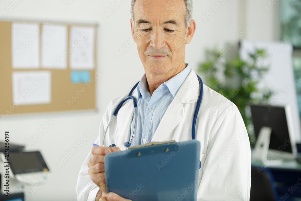 senior man doctor in white uniform holding clipboard senior man doctor in white uniform holding clipboard