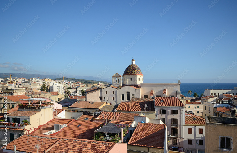 view of Alghero, city of Sardinia, with the Mediterranean sea and the hills in the background