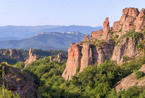 Magnificent rocks among the forest at sunrise. Belogradchik, Bulgaria photo