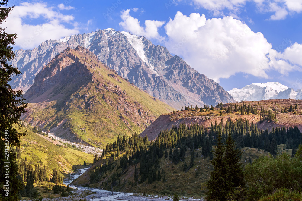 View of the beautiful Left Talgar mountain valley with river, rocks and forest in Tian Shan mountains near Almaty city; best place for active lifestyle, hiking and trekking in Kazakhstan. View of the beautiful Left Talgar mountain valley with river, rocks and forest in Tian Shan mountains near Almaty city; best place for active lifestyle, hiking and trekking in Kazakhstan.