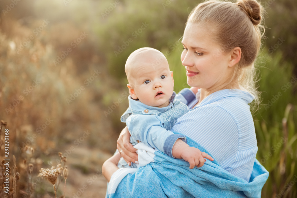 Portrait of beautiful young mother holding her baby toddler. Happy family, mother and child play concept Portrait of beautiful young mother holding her baby toddler. Happy family, mother and child play concept