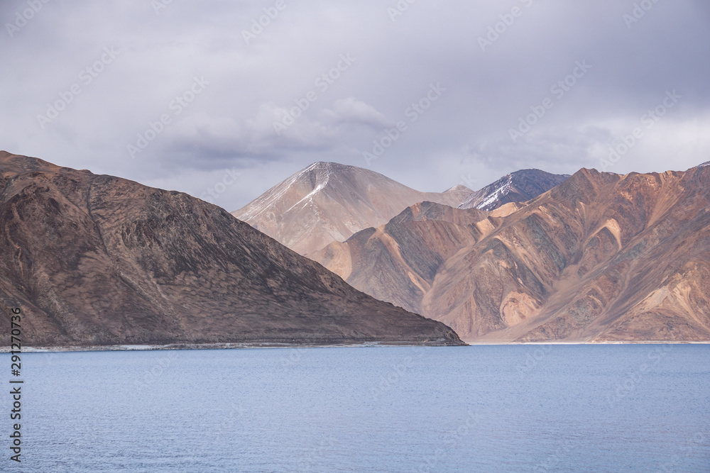 Pangong Lake with rocky mountains situated on the border with India and China in Ladakh region Pangong Lake with rocky mountains situated on the border with India and China in Ladakh region