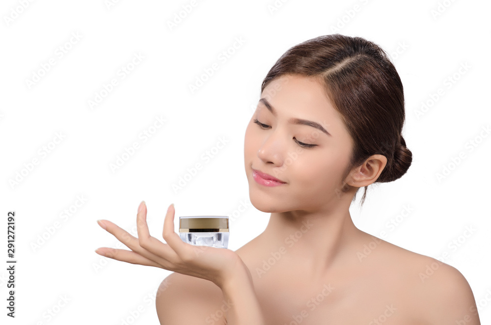 asian young beautiful woman smiling holding cream jar in her hand and point the finger at the cream.isolated on white background asian young beautiful woman smiling holding cream jar in her hand and point the finger at the cream.isolated on white background