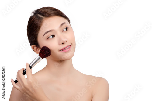 Short hair asian young beautiful woman looking and touch her chin with powder brush,natural makeup, skincare, cosmetology and plastic surgery concept