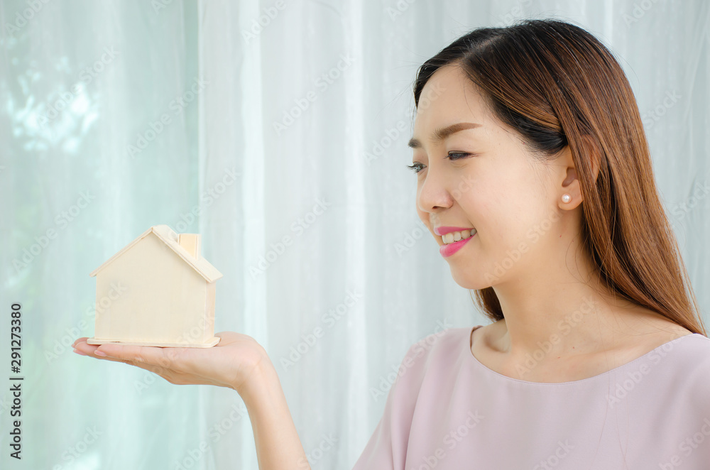 Architecture, building, construction, real estate and property concept, Happy woman hands holding wood house close up Architecture, building, construction, real estate and property concept, Happy woman hands holding wood house close up
