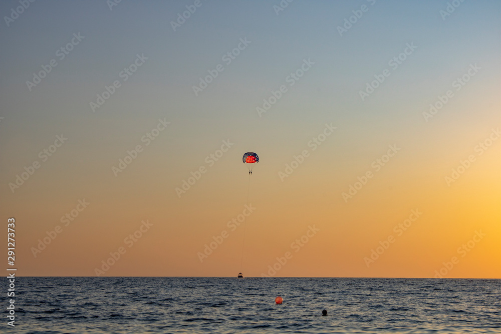 Parachuting over the sea in the evening is especially pleasant Parachuting over the sea in the evening is especially pleasant