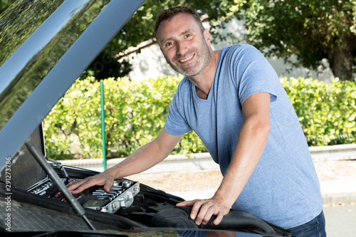 happy man fixing a car photo