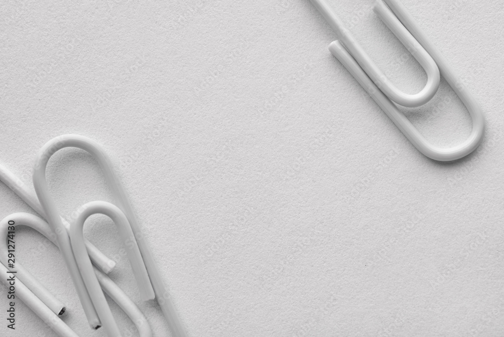 White plastic paper clips with copy space