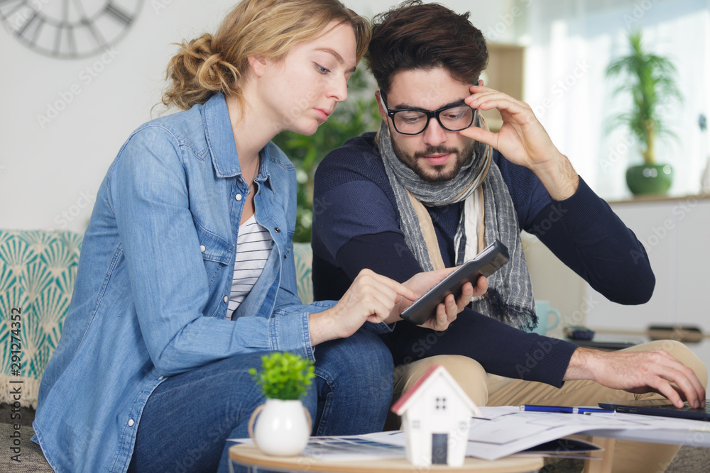 couple researching housing possibilities on a tablet couple researching housing possibilities on a tablet