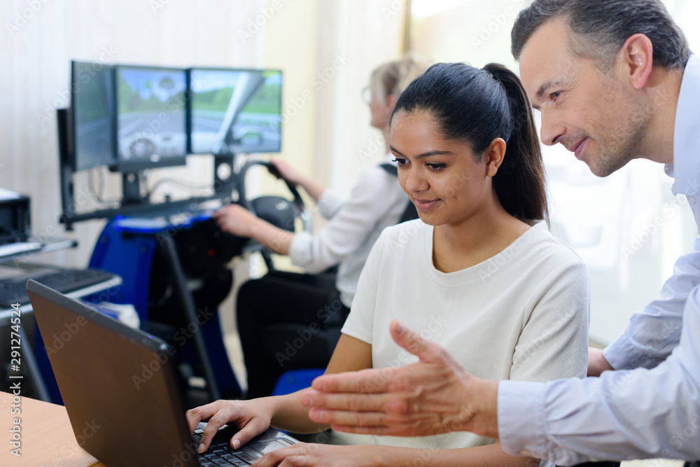 woman on computer while learning to drive woman on computer while learning to drive