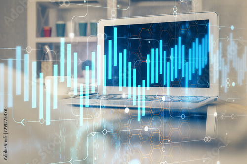 Financial chart drawing and table with computer on background. Double exposure. Concept of international markets. © peshkova