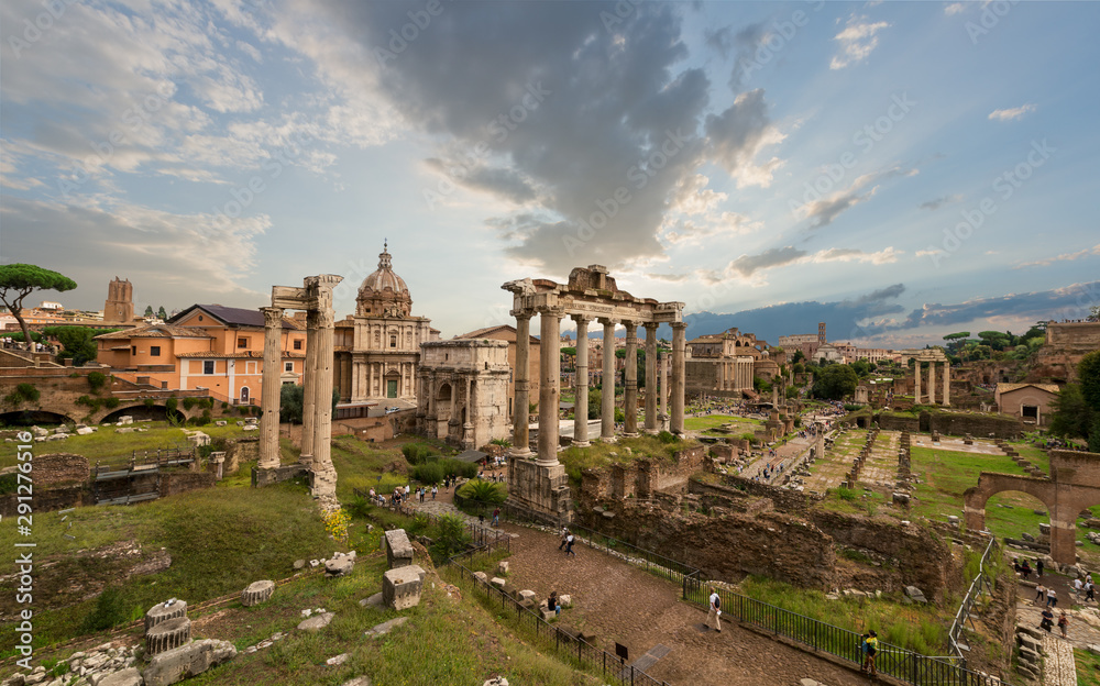 Image of Roman Forum in Rome, Italy during sunset in sunny day. View of Roman Forum with the Temple of Saturn and Vespasian, Rome, Italy.  Roman Forum is one of the main travel destinations in Europe.
