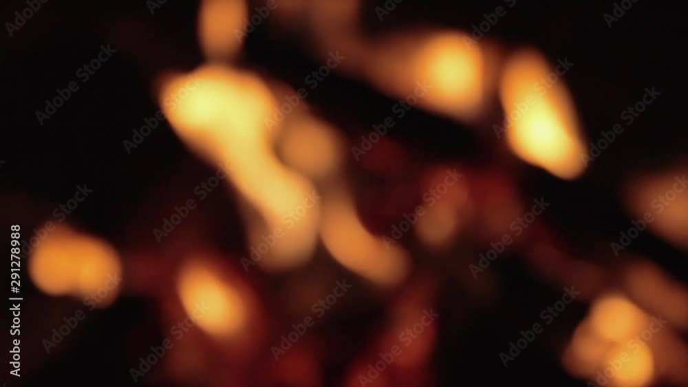 Defocus. Shot close-up in slow motion of a fire in a stove and fireplace. Burning firewood and paper from books and newspapers. House heating. Gas shutdown