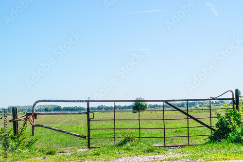 Iron gate in dutch polder landscape